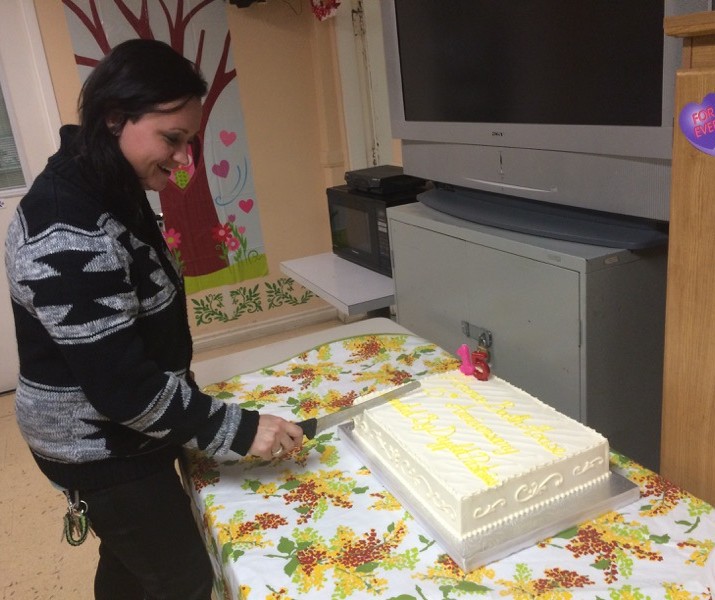 image of a woman cutting a cake